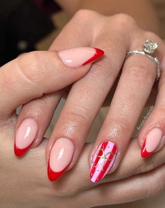 long aesthetic almond red pink Christmas nail art with gold hand drawn bow on red tips