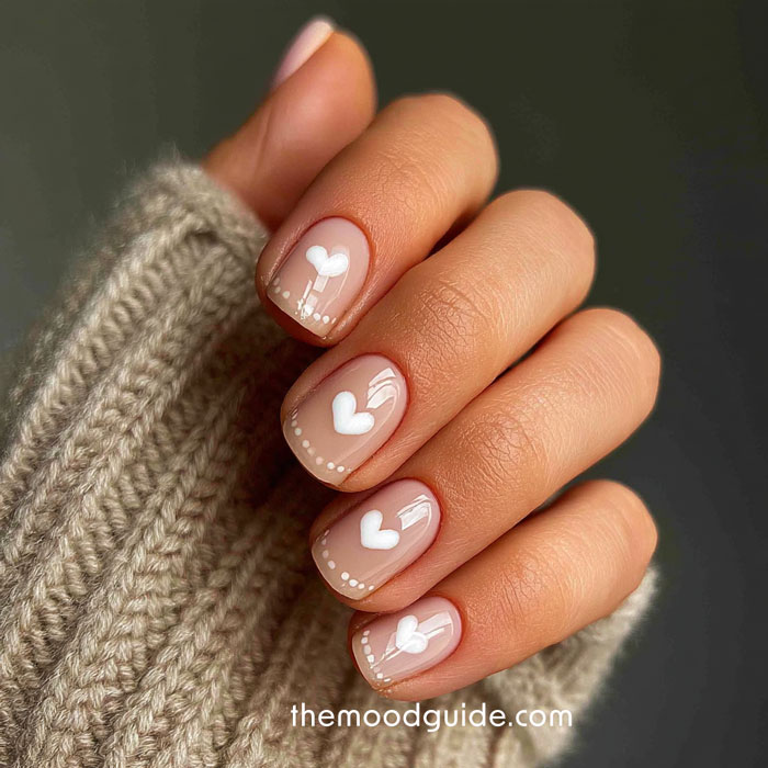 aesthetic beige nails with white heart design for valentines day manicure